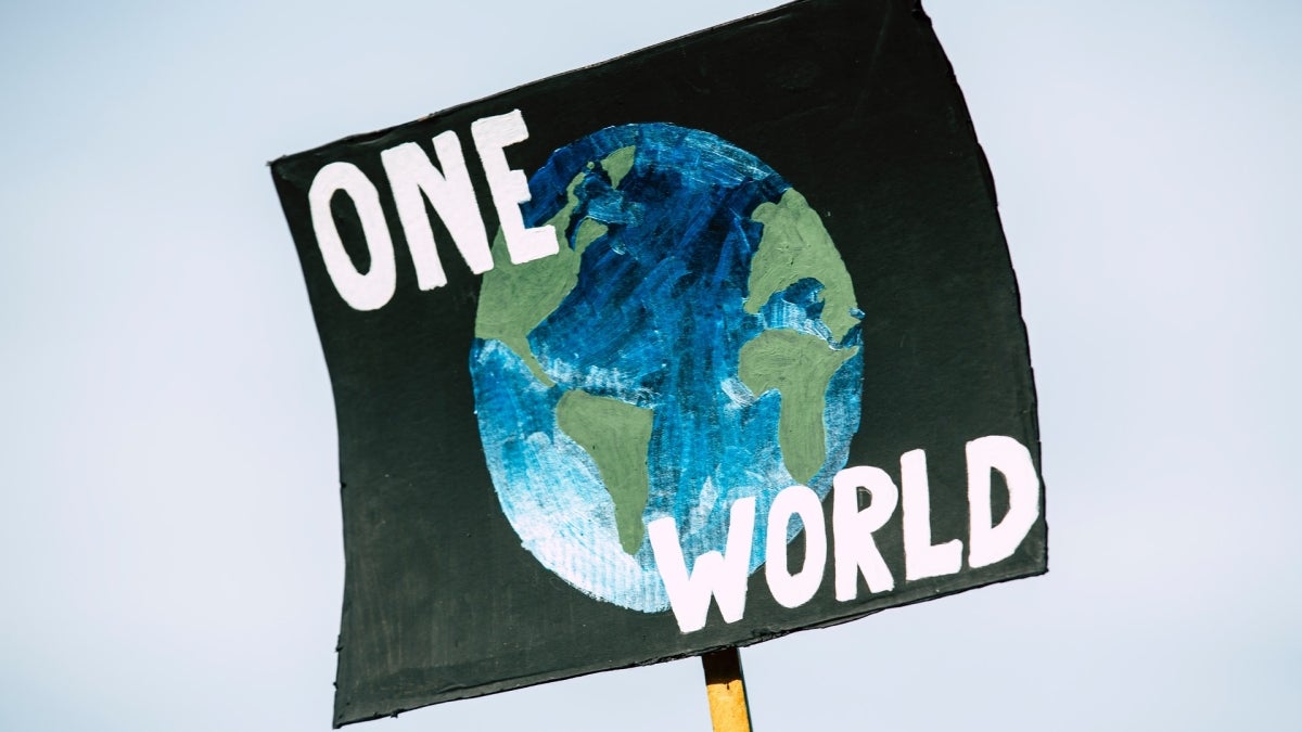 Poster with a drawing of Earth on it that reads: "One World."