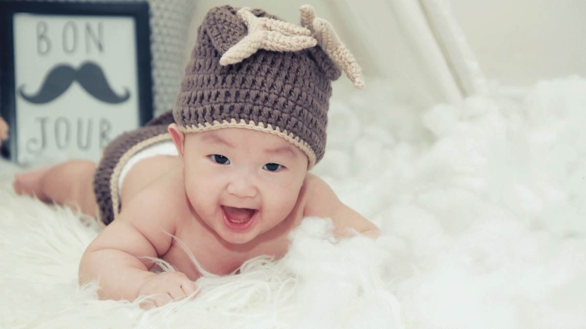 Baby on a feather-covered surface