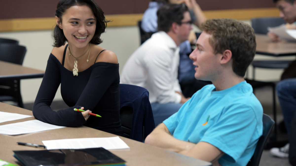 Students talking in a classroom.