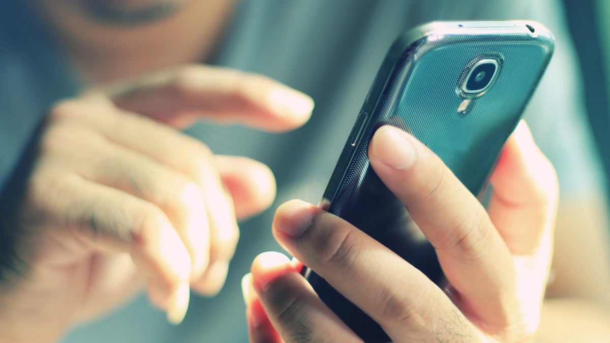 A closeup of hands holding a smartphone