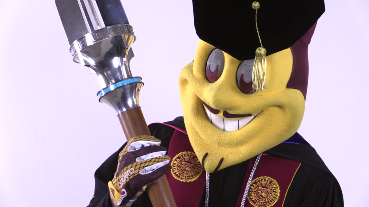 Sparky holding university mace