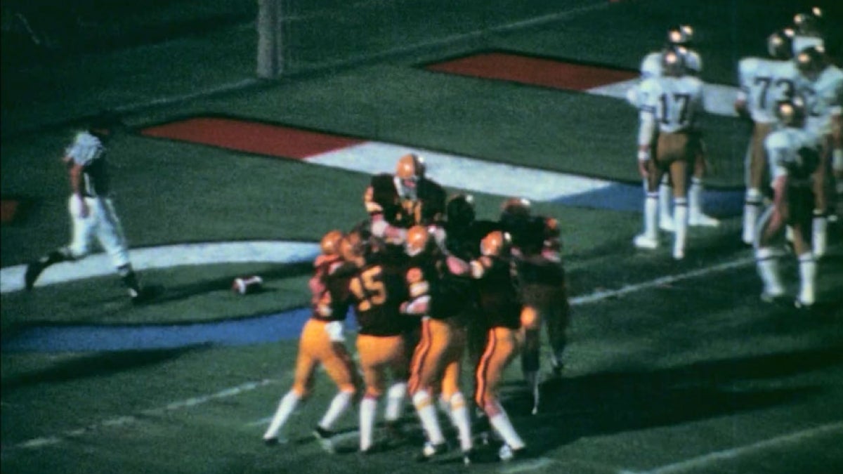 group of football players huddled together 