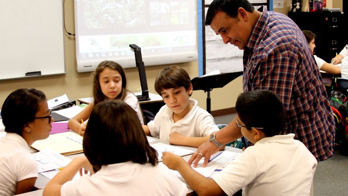 teacher instructing students in a classroom