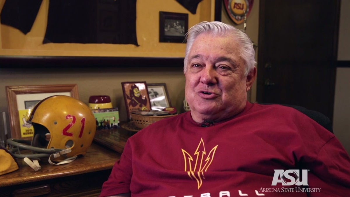 Man sitting next to trophy case