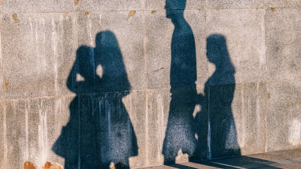 photo of people's shadows on wall