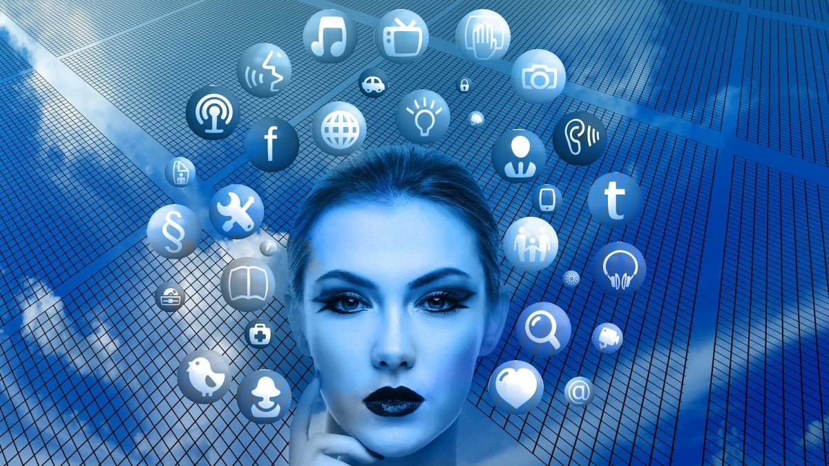 Graphic illustration of a woman's face with various media-realted icons surrounding her.