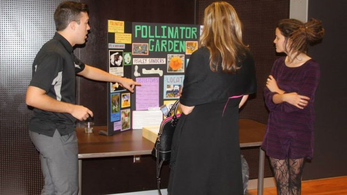 Students make a presentation about a pollinator garden.