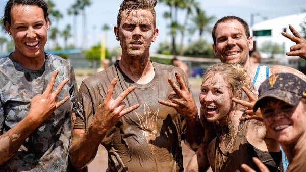 People muddy and posing.