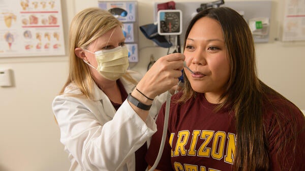 A nurse examines a patient