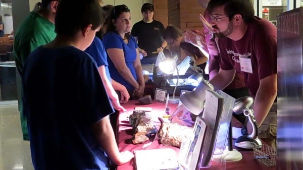 community members look at meteorites and engage with ASU scientists