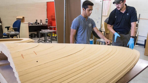 Students look at the layered model of the AZ Loop pod