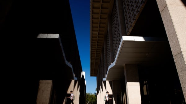 Student walking into Hayden Library