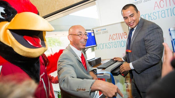 Men and a big bird at a treadmill desk