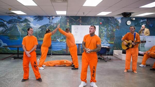 Inmates act in a prison theater program.