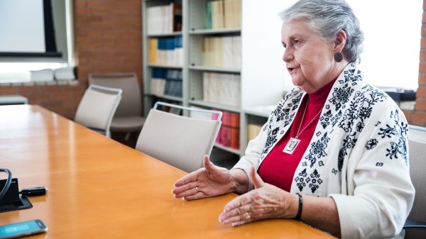 ASU Regents&#039; Professor Jane Buikstra speaks while seated in a conference room.