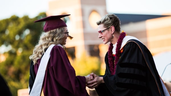 Dean Marlene Tromp and a student at the New College convocation