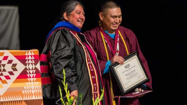 Professor presents the Dean’s Medal to American Indian Studies graduate