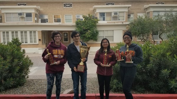 students holding trophies