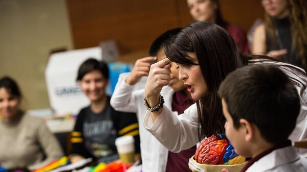 professor holding brain model