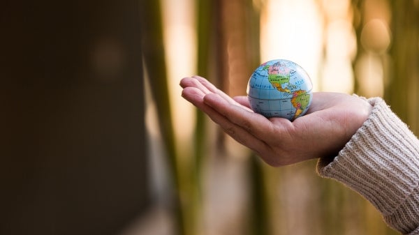 hand holding small globe