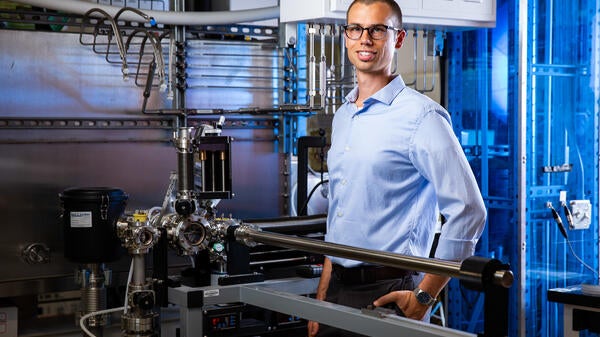 Portrait of ASU professor Zachary Holman featured in his lab.