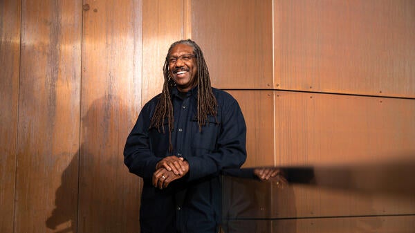 Man in black shirt and pants smiling