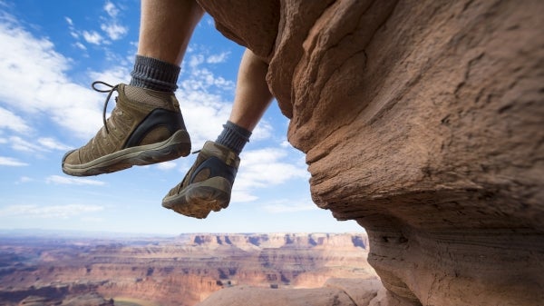 Feet hanging over Grand Canyon