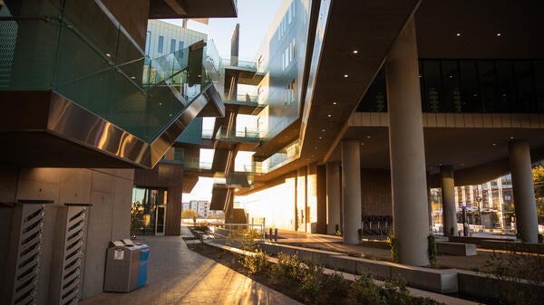 A courtyard of a building is lit by the early morning sun.