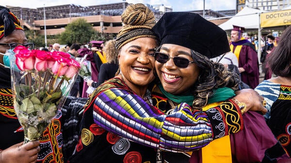 Friend hugging recent ASU graduate