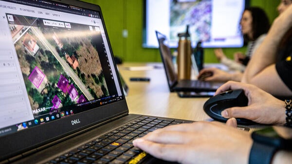 Person using mapping software on laptop