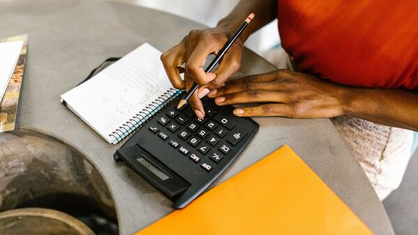 Woman using calculator at table