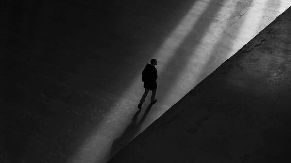 A man walks alone at night.