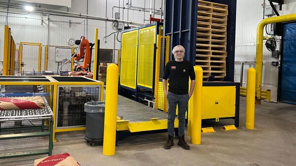 A photo of Tyler Jiemback in a Lallemand Baking facility, surrounded by machinery.