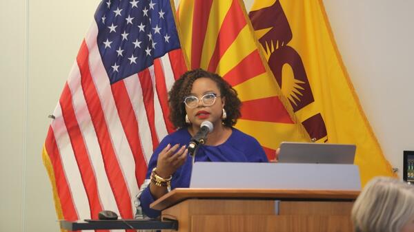 Fallon Wilson speaks from a lectern