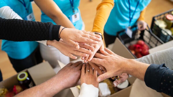 People putting their hands in together