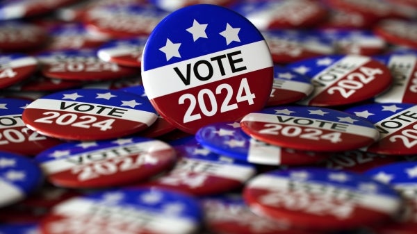 Red white and blue buttons that say VOTE 2024