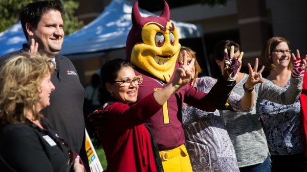 ASU Sparky mascot poses for a photo with ASU staff