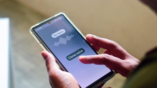 Person holding phone that is open to voice cloning app