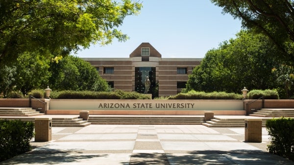 ASU, Arizona State University, Glendale, Arizona, ASU West campus, sign, library In front of the ASU West Campus Main entrance, a statue is visble, behind which lies the Fletcher library. This sculpture title "Reading"