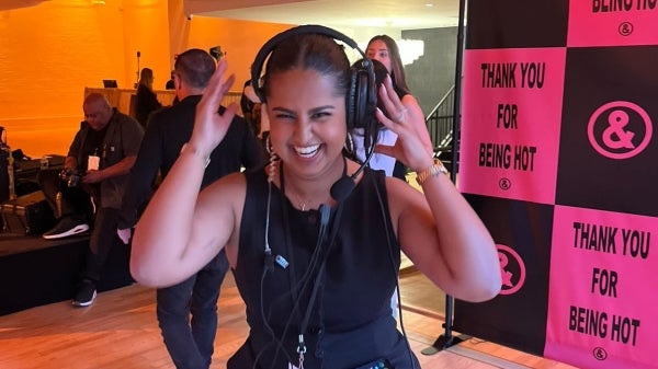 woman smiling while wearing a headset