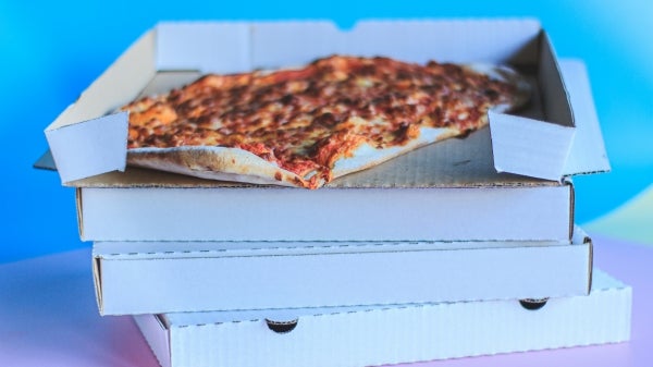 A stack of four pizza boxes