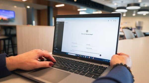 A photo of someone using ChatGPT on their laptop