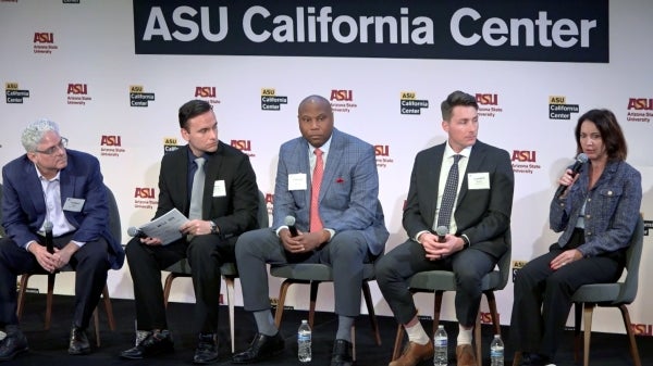 Group of five panelists sitting on stage holding microphones in front of sign that says ASU California Center