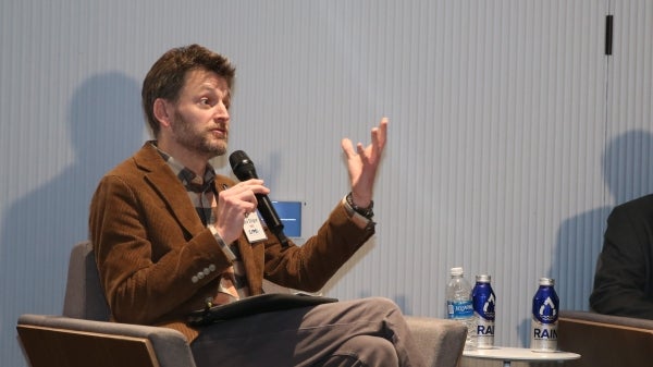 Jack Stilgoe, seated, speaks to an unseen audience