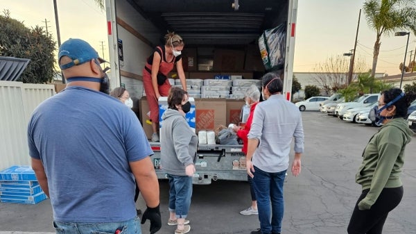 People loading a UHaul with supplies for DIY air filtration system