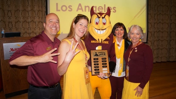 Group of people standing with ASU mascot Sparky and smiling.