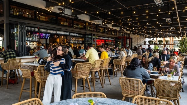 Large patio of a crowded restaurant.