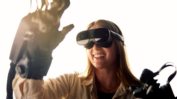 A woman named Amber Hedquist uses VR goggles in her language research. Photo from ASU Thrive September 2024 issue.