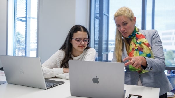 Annalise Vallarde (left) and mentor Sabine Botha review the latest state-of-the-art AI tools to help in the data analysis for the ASU CXFEL project.