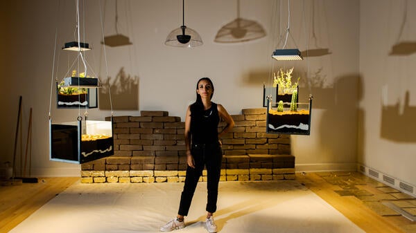 woman standing in mixed-media exhibit